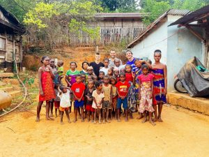 A group picture next to the house of Fanja